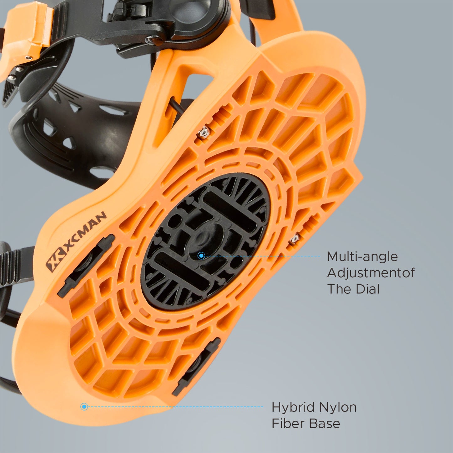 Bottom baseplate view of XCMAN 360 Seco Pro black and orange snowboard bindings showing the hybrid nylon fiber base and multi-angle adjustment dial