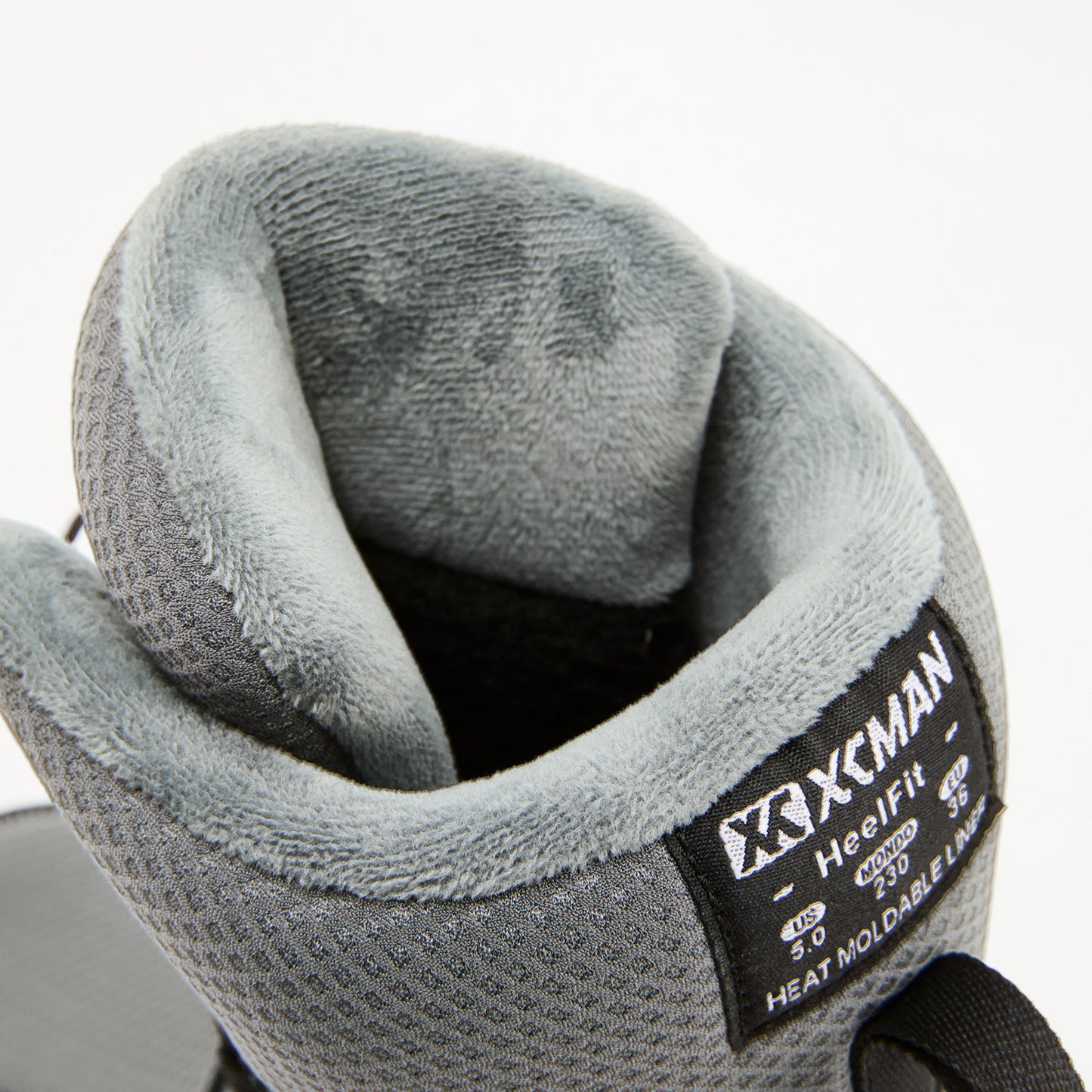 Detailed view of the internal harness, tongue, and secure strap system inside XCMAN NOX-II boots